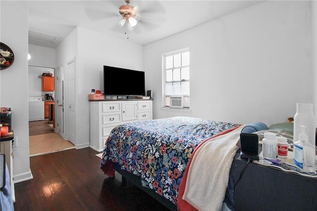 bedroom featuring ceiling fan, washer / clothes dryer, cooling unit, and dark hardwood / wood-style flooring