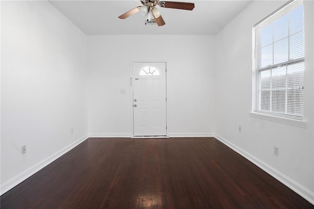 empty room featuring dark hardwood / wood-style floors and ceiling fan