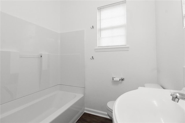 bathroom featuring shower / bath combination, wood-type flooring, and toilet