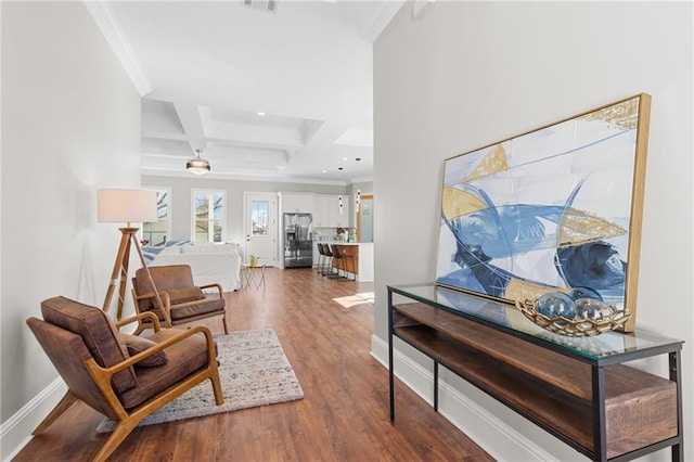 interior space with coffered ceiling, ornamental molding, hardwood / wood-style floors, and beam ceiling