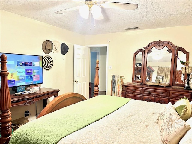 bedroom with a textured ceiling and a ceiling fan