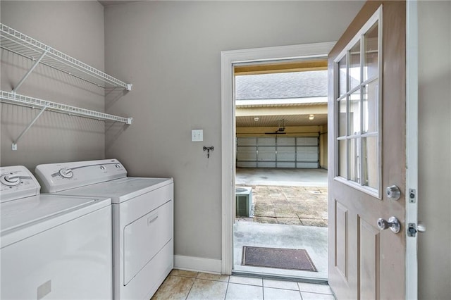 washroom featuring light tile patterned flooring and washing machine and clothes dryer