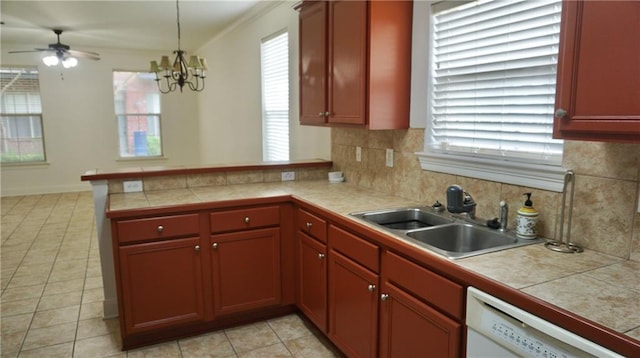 10600 Lakes Blvd Unit 901, Baton Rouge, LA 70810 - kitchen featuring a sink, white dishwasher, a peninsula, decorative backsplash, and light tile patterned floors