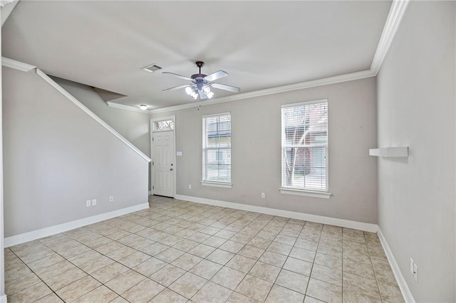 spare room featuring light tile patterned floors, ceiling fan, and ornamental molding