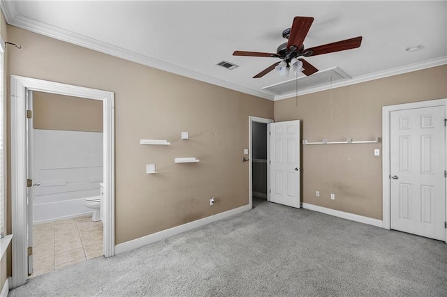 unfurnished bedroom with ceiling fan, ornamental molding, ensuite bath, and light carpet