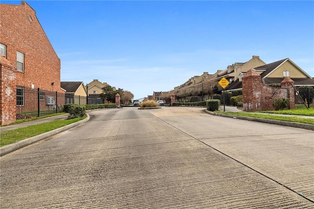 10600 Lakes Blvd Unit 901, Baton Rouge, LA 70810 - view of concrete street featuring sidewalks, a residential view, and curbs