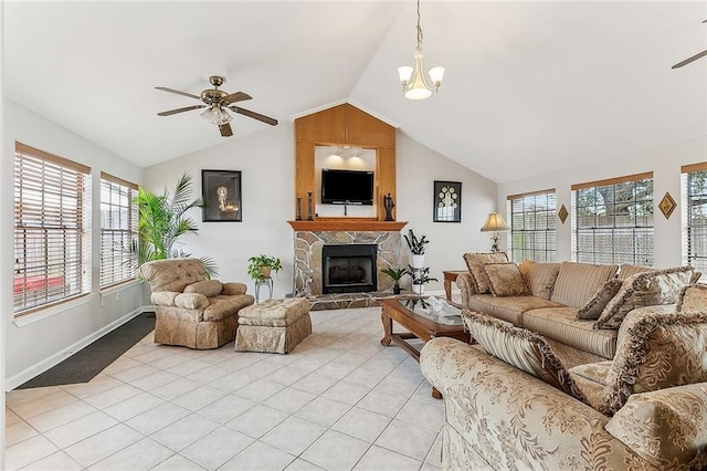 tiled living room featuring a fireplace, vaulted ceiling, and ceiling fan with notable chandelier