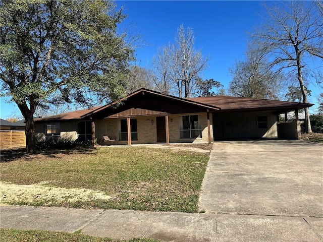 ranch-style house featuring a front yard and a carport