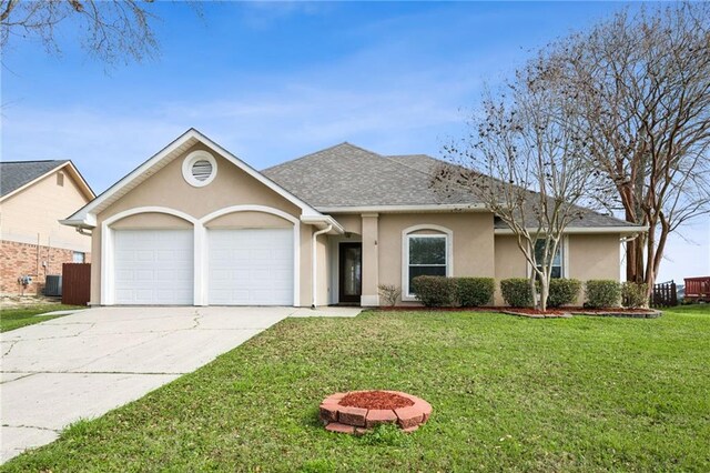 single story home featuring an attached garage, a shingled roof, concrete driveway, stucco siding, and a front yard