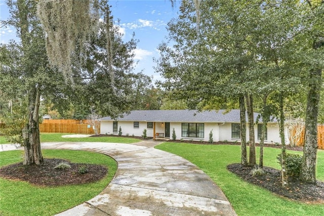 ranch-style home with a front lawn