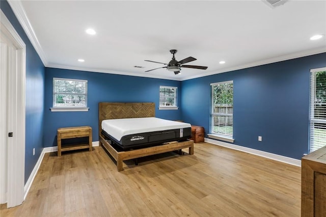 bedroom with ceiling fan, light wood-type flooring, and crown molding
