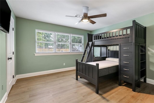 bedroom with light hardwood / wood-style floors and ceiling fan