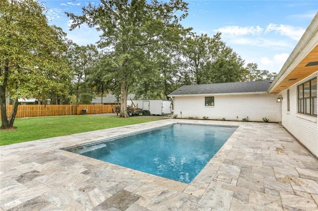 view of pool featuring a yard and a patio area