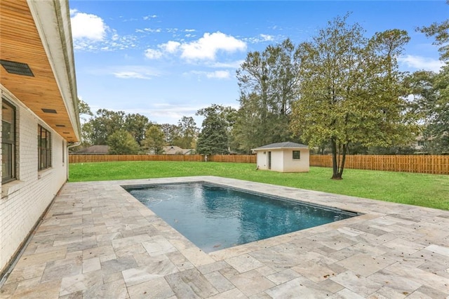 view of swimming pool featuring a storage unit, a patio area, and a lawn