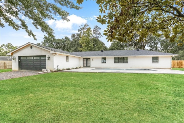single story home featuring a patio, a front lawn, and a garage