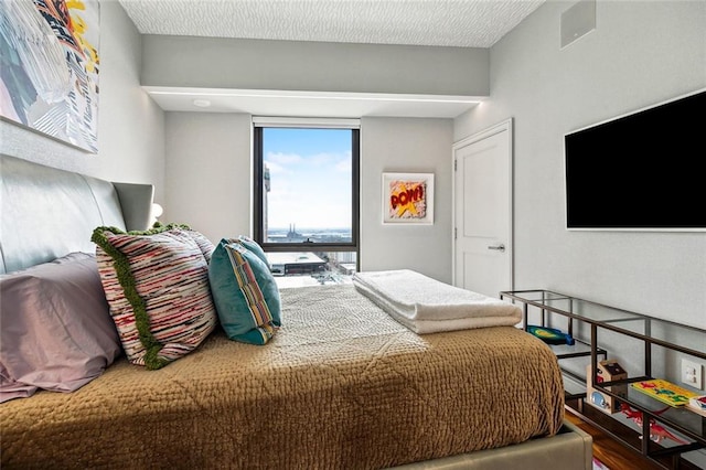 bedroom with wood finished floors and visible vents