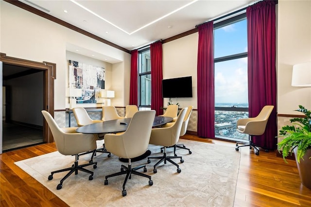 office featuring a healthy amount of sunlight, wood finished floors, and recessed lighting
