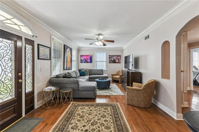 living room with ornamental molding, wood finished floors, and visible vents