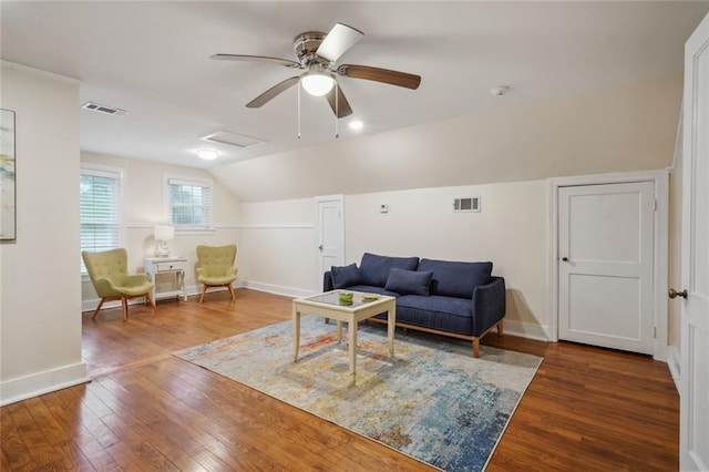 living area with wood-type flooring, visible vents, vaulted ceiling, and baseboards