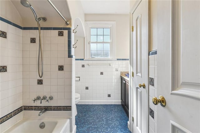 full bathroom with toilet, vanity, tile walls, shower / bathing tub combination, and tile patterned floors