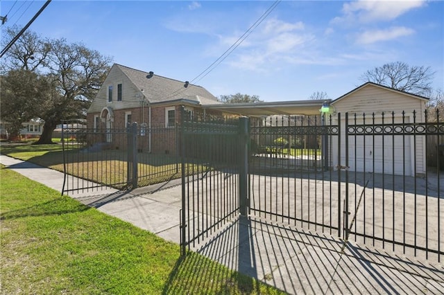 view of gate featuring a fenced front yard and a lawn