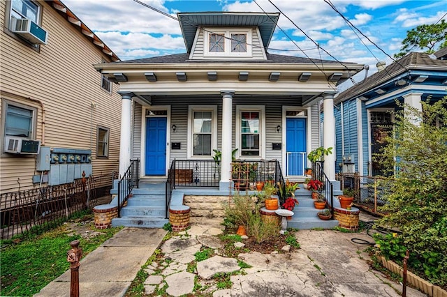 view of front facade with a porch and cooling unit