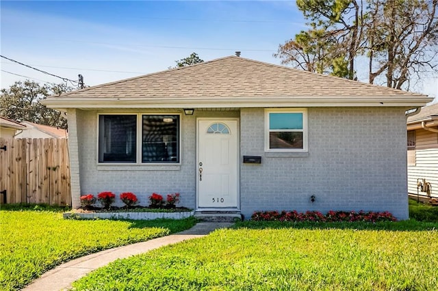 bungalow-style home featuring a front yard