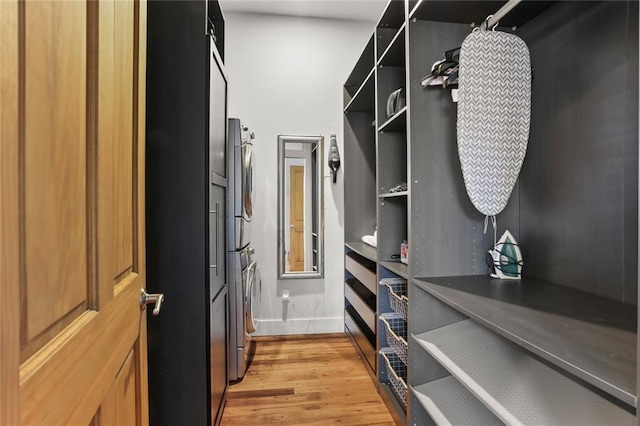 900 Delachaise St, New Orleans, LA 70115 - walk in closet with stacked washer / drying machine and light hardwood / wood-style floors