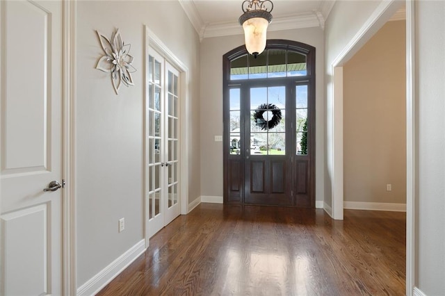 entrance foyer with dark hardwood / wood-style floors and ornamental molding