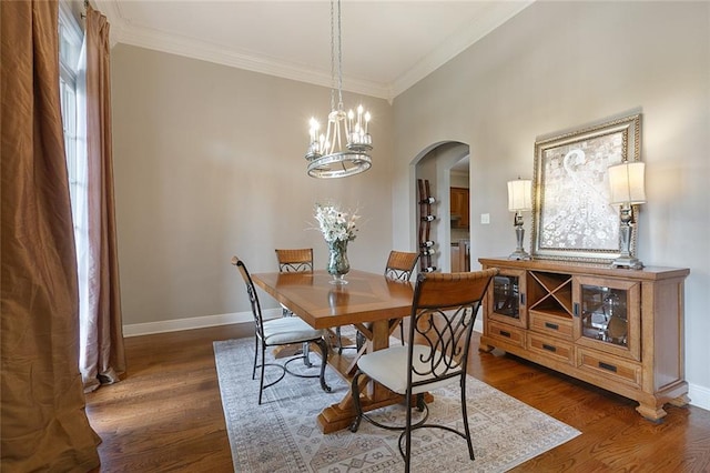 dining space featuring a chandelier, crown molding, and dark hardwood / wood-style floors