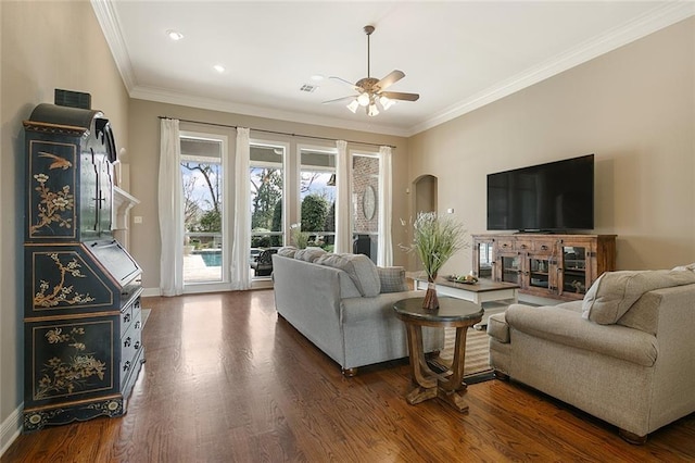 living room with ceiling fan, dark hardwood / wood-style flooring, and ornamental molding