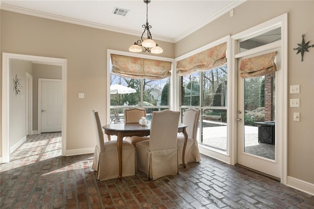 dining space featuring crown molding and a chandelier