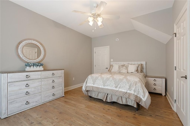 bedroom featuring ceiling fan, light hardwood / wood-style flooring, and vaulted ceiling