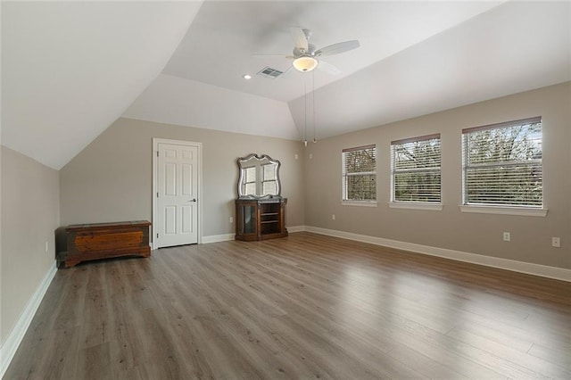 bonus room with ceiling fan, lofted ceiling, and wood-type flooring