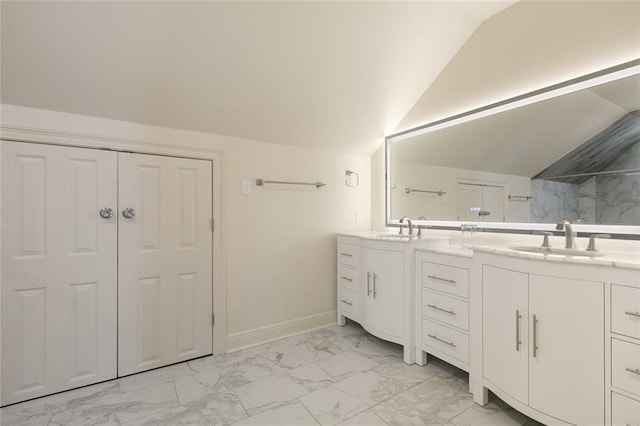 bathroom featuring vanity, vaulted ceiling, and walk in shower