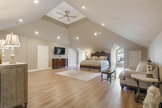 bedroom featuring ceiling fan, light hardwood / wood-style floors, and vaulted ceiling