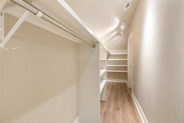 spacious closet with light hardwood / wood-style floors