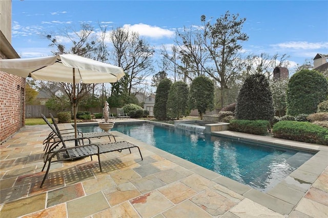 view of pool featuring an in ground hot tub and a patio