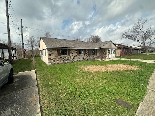 ranch-style home with a front lawn