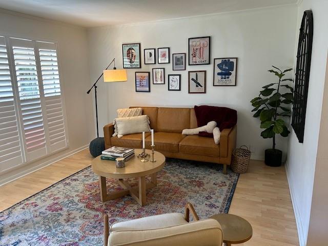 4007 St Charles Ave Unit 319, New Orleans, LA 70115 - living room with wood finished floors and crown molding