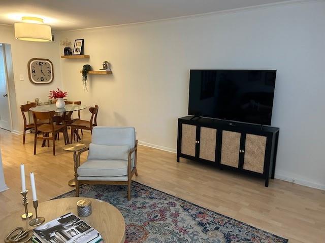 4007 St Charles Ave Unit 319, New Orleans, LA 70115 - living room with ornamental molding and wood finished floors