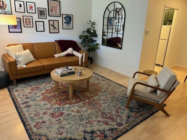 living room featuring baseboards and wood finished floors