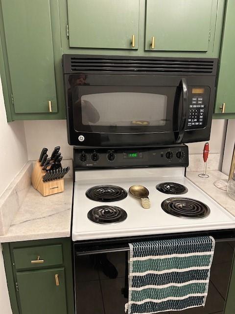 4007 St Charles Ave Unit 319, New Orleans, LA 70115 - kitchen featuring green cabinets, black microwave, and electric range