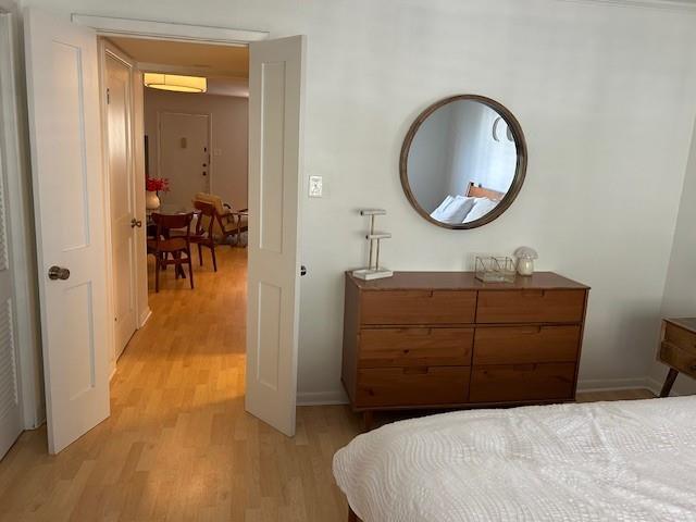4007 St Charles Ave Unit 319, New Orleans, LA 70115 - bedroom featuring light wood-style floors