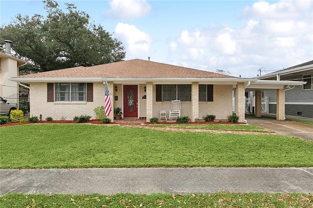 ranch-style house featuring a front yard and a carport