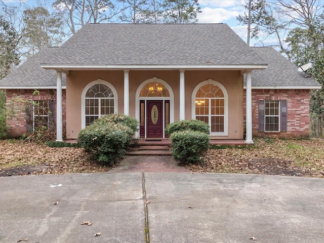 1220 Atalin St, Mandeville, LA 70448 - view of front of home featuring a shingled roof and stucco siding