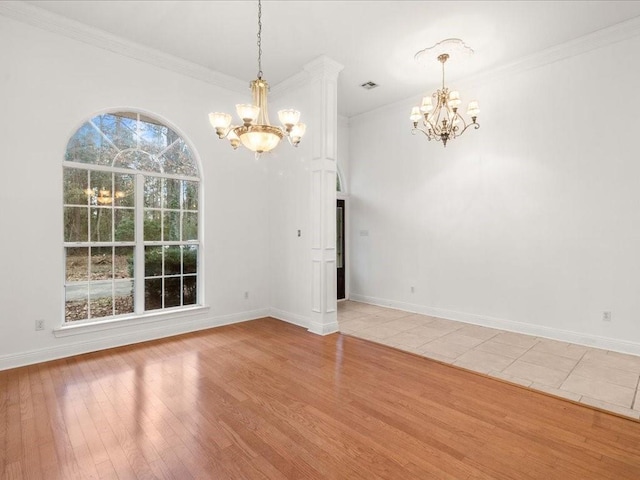 unfurnished dining area with ornamental molding, an inviting chandelier, and hardwood / wood-style floors