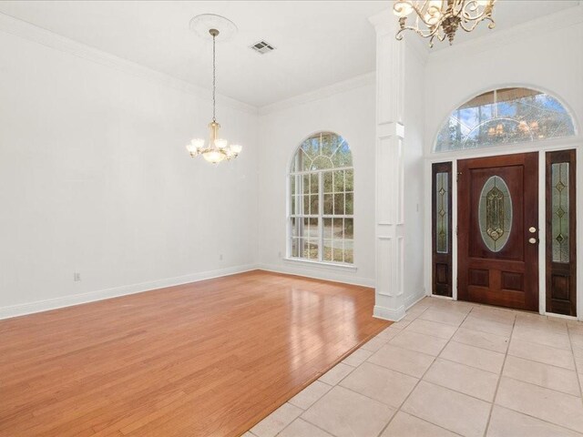 1220 Atalin St, Mandeville, LA 70448 - entrance foyer with a chandelier, plenty of natural light, crown molding, light wood-style flooring, and baseboards