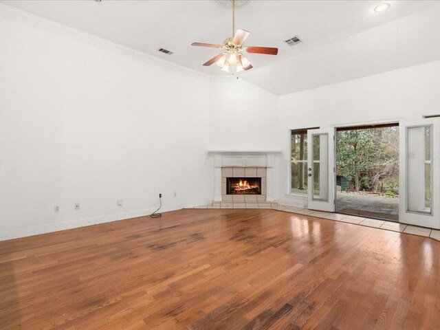 1220 Atalin St, Mandeville, LA 70448 - unfurnished living room featuring a tiled fireplace, wood finished floors, a ceiling fan, baseboards, and crown molding