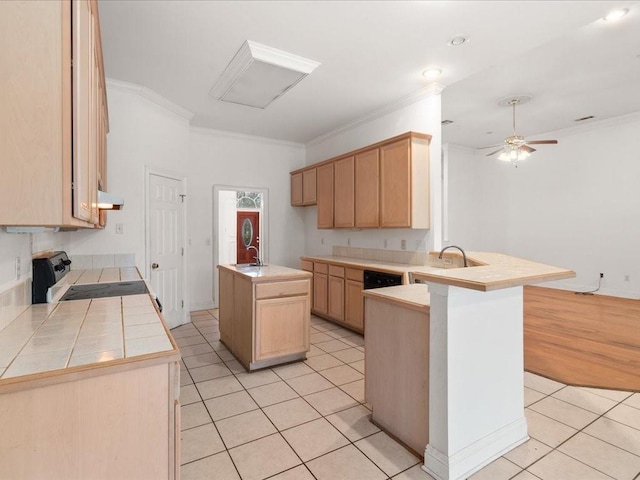 kitchen featuring a center island with sink, kitchen peninsula, range, light brown cabinetry, and light tile patterned flooring